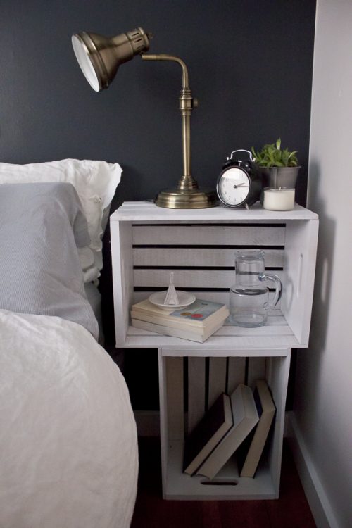 Stacked white crates being used as a nightstand