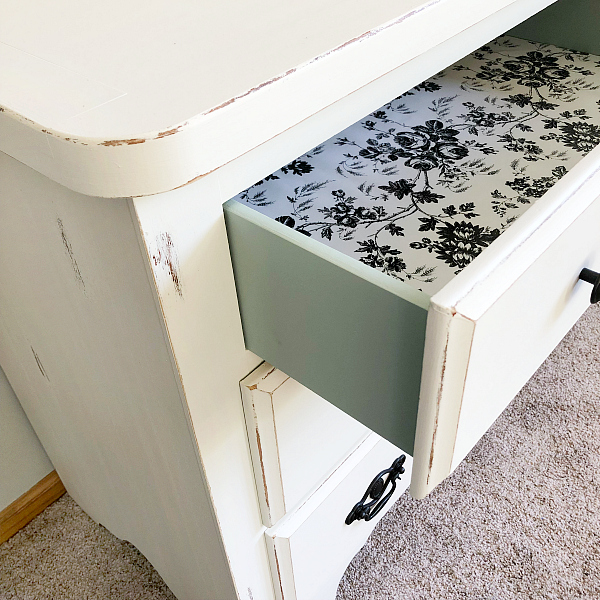 Dresser makeover showing a pop of color when opening the drawers as the drawers are painted in Inglenook and each drawer is lined in black and white floral liners