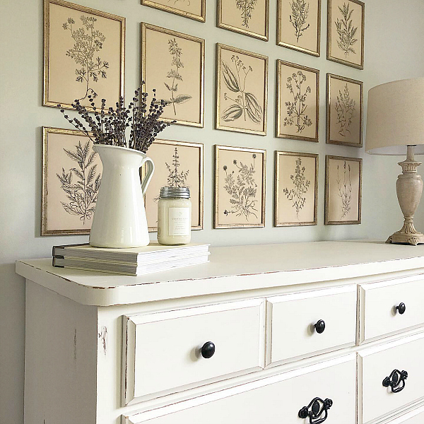 Farmhouse style gallery wall hung on a master bedroom wall above a distressed dresser