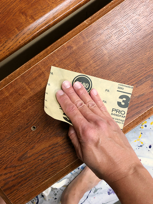 Lightly sanding dresser drawers prior painting with Fusion Mineral Paint