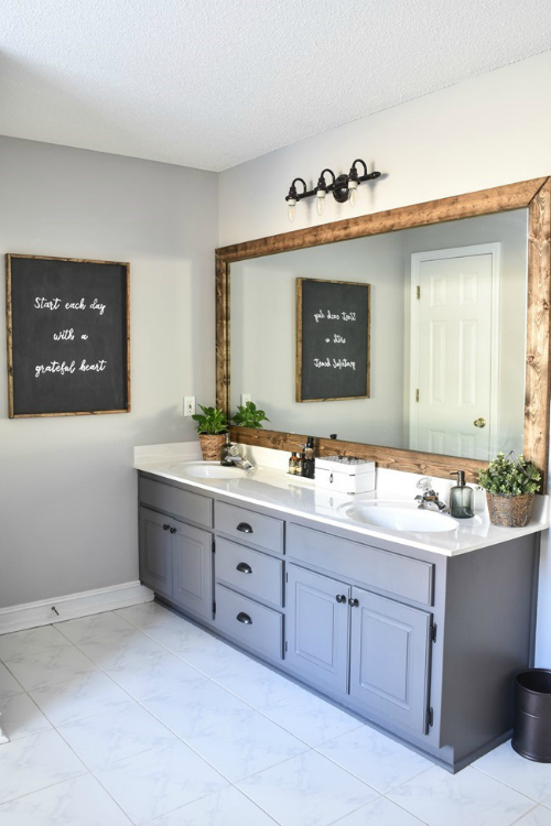 $100 Bathroom Makeover Reveal featuring a wood framed mirror, painted vanity, and large chalkboard sign