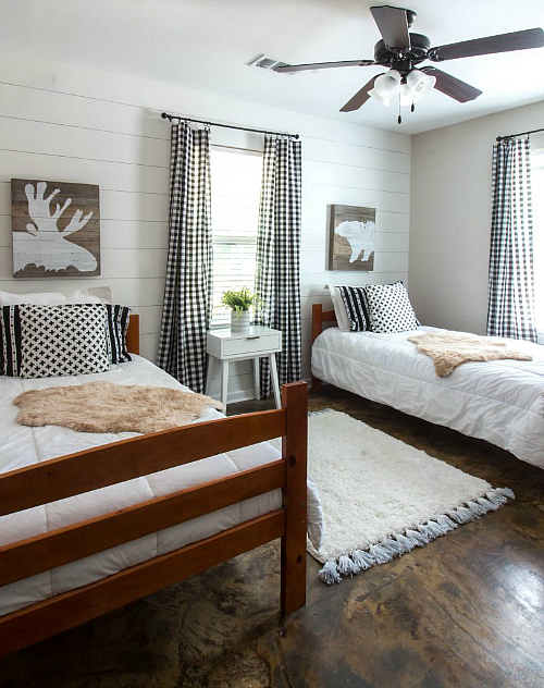 Lake cabin bedroom after $100 Room Challenge: featuring faux shiplap walls, buffalo check curtains, and wood wall art