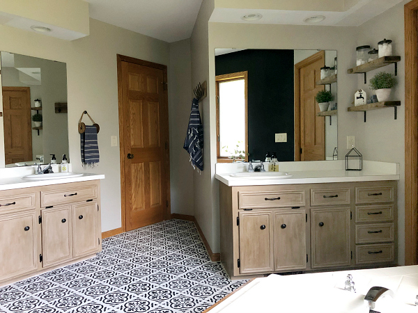 $100 Bathroom Makeover showing vanities that were made over with chalk paint and wax, along with a black and white stenciled floor