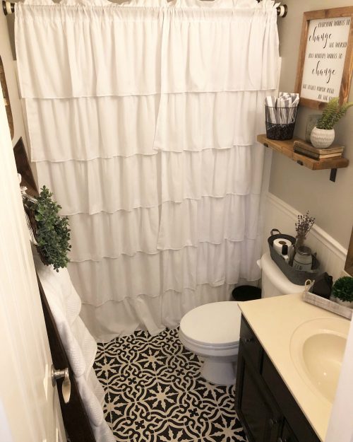 Gorgeous farmhouse bathroom with stenciled floor from Wilshire Collections.