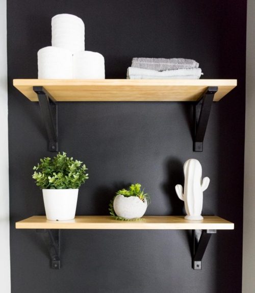 Open Shelving Against a Black Bathroom Wall- By Brittany Goldyn