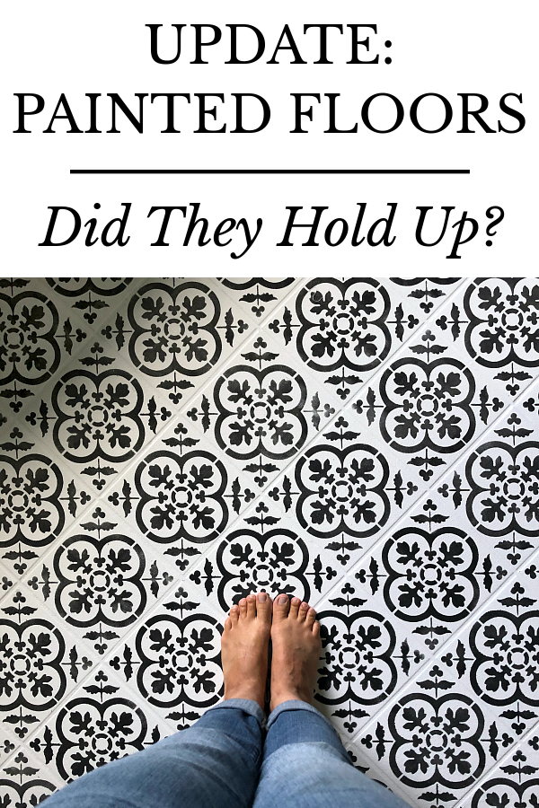 Black and white stenciled tile floor in bathroom