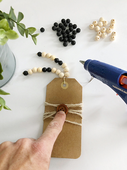 Gluing wood button to DIY diffuser bookmark