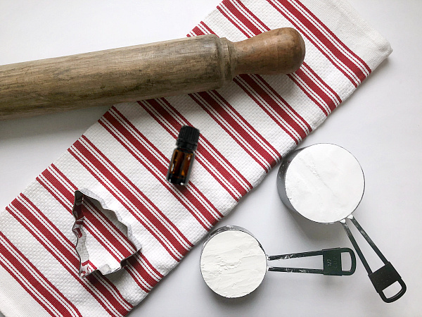 Items needed to make scented clay ornaments: baking soda, corn starch, essential oil