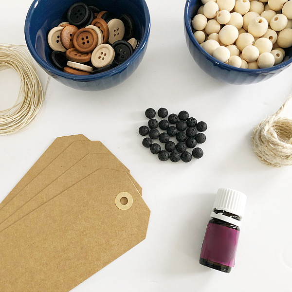 Items needed to make a diffuser bookmark: tags, essential oil, lava beads, etc
