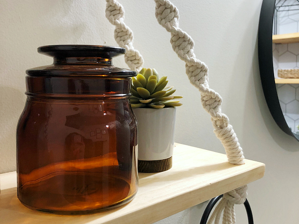 DIY Hanging wood shelf with small plant and amber glass jar