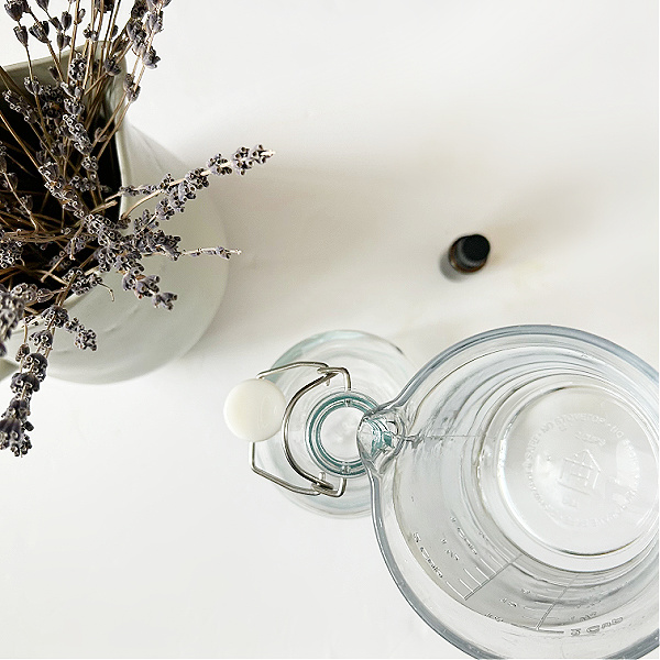 Adding vinegar to glass bottle to make fabric softener