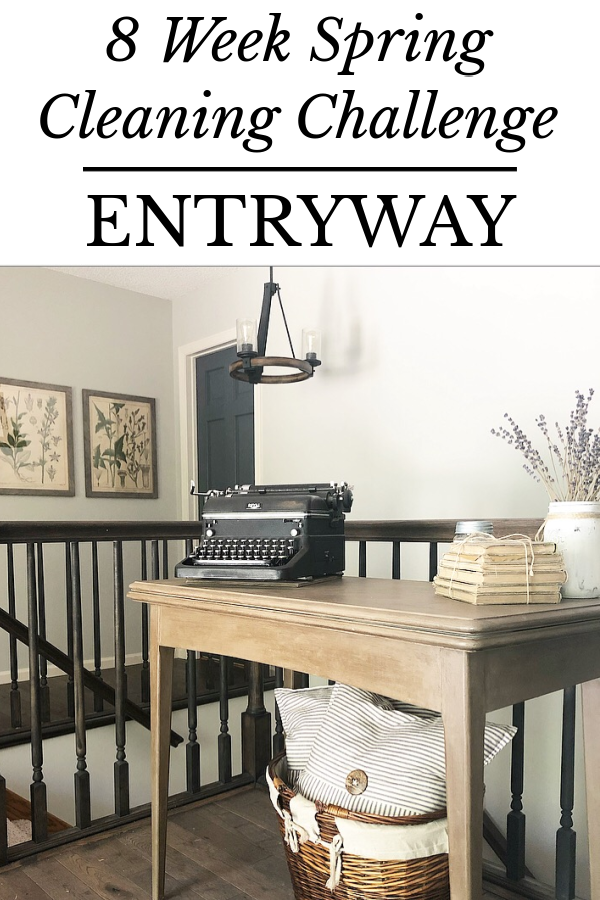 Farmhouse style entryway with painted wood table and basket holding pillows beneath it