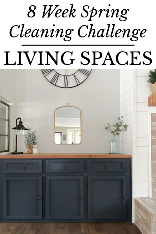 Cabinet in living room with a mirror and large clock hanging on the walls above