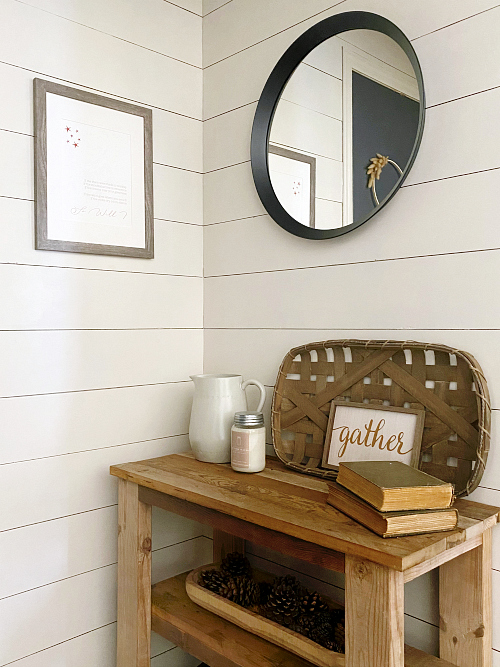 Wall decor for a farmhouse entry makeover including a round mirror and DIY print