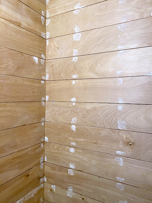 Nail Holes being filled on shiplap wall