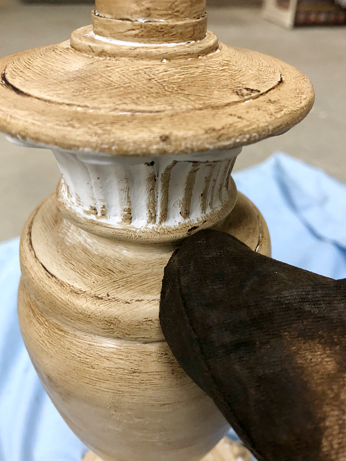 Applying dark wax to lamp base