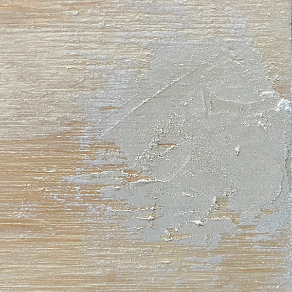 Applying wood filler to hole where screws were put into faux vanity