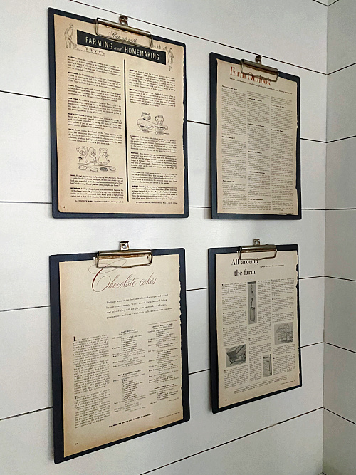 Gallery wall of DIY Vintage Clipboards hanging on shiplap wall