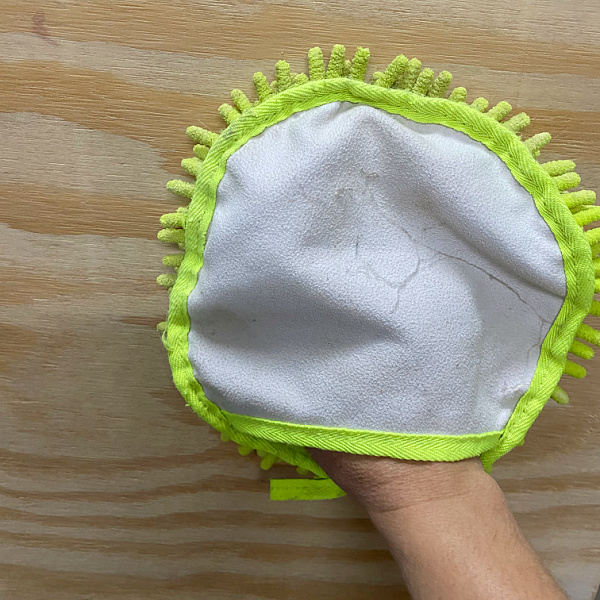 Dusting vanity frame with microfiber dusting mitt prior to priming and painting