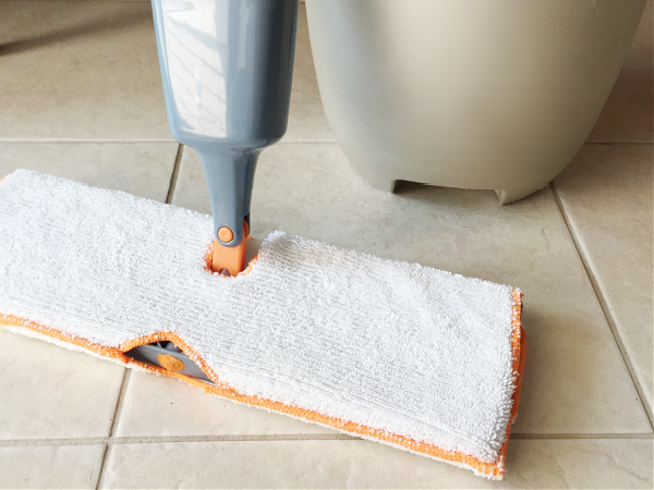 Mop and bucket on tile floor