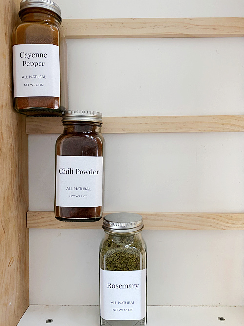 Convenient Spice Drawer Organization with Glass Jars and Labels