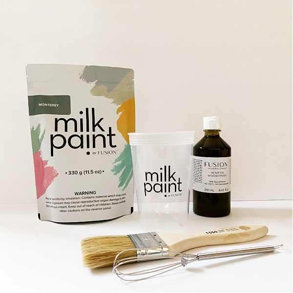 Items needed to paint with milk paint: milk paint, brush, cup and whisk, and Hemp Oil