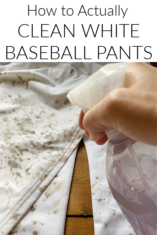 Spraying dirty baseball pants with a DIY stain remover