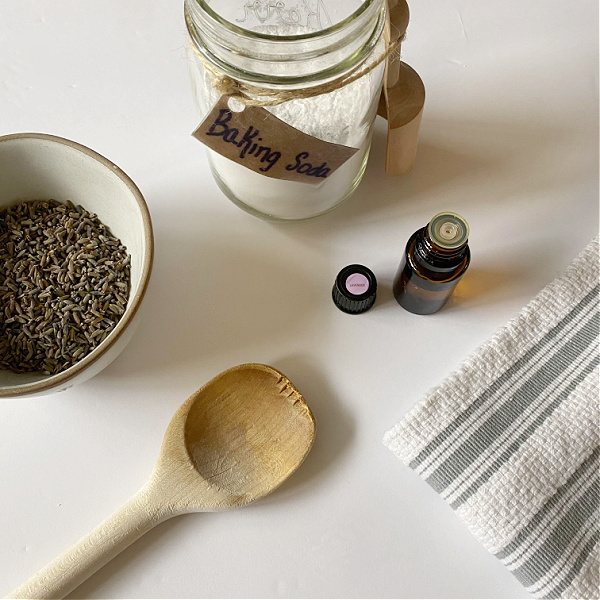 Items needed to make DIY Carpet Powder: Baking Soda, Essential Oil, and dried herbs (optional)