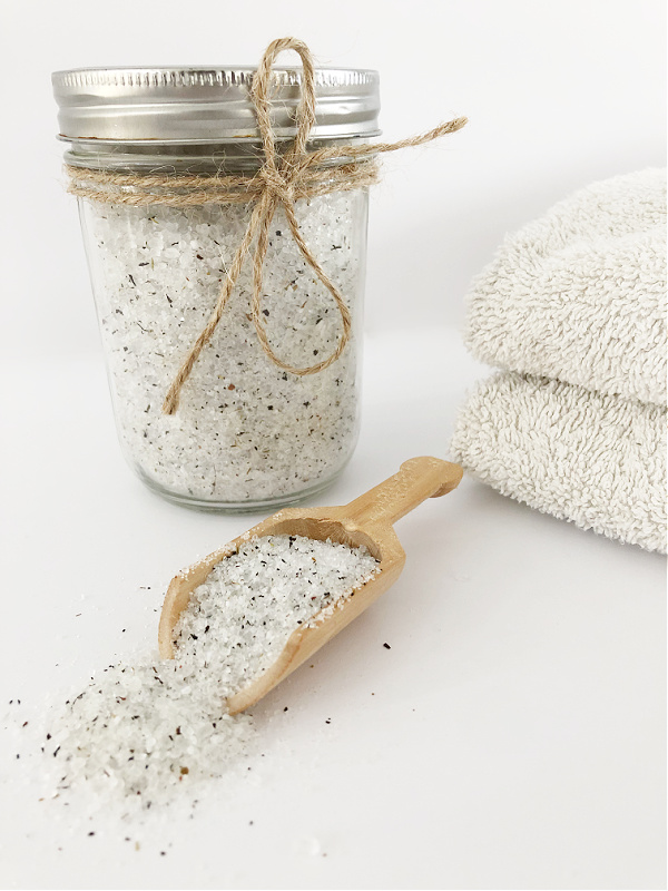 Homemade foot soak made with tea and Epsom salt in jar with wooden scoop