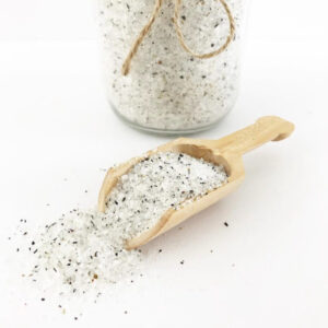 Homemade foot soak made with Epsom salt and tea in a jar with a wooden scoop