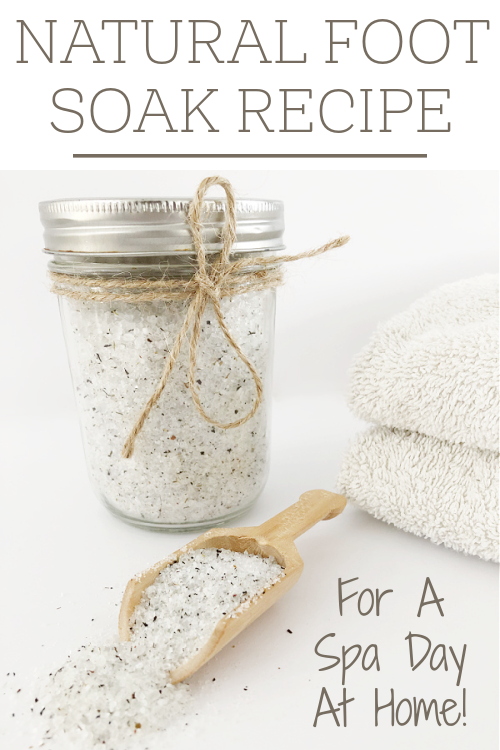 Homemade foot soak in a small glass jar with a wooden scoop