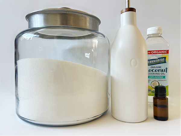 Ingredients needed to make homemade sugar scrub: Sugar, coconut oil, olive oil and essential oil