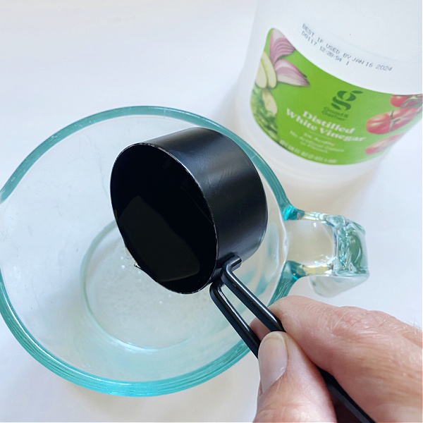 Adding vinegar to Homemade Shower Cleaner Recipe