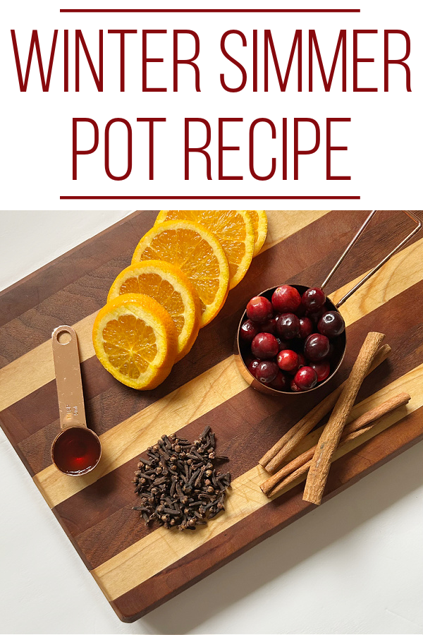 Ingredients for winter simmer pot sitting on wood cutting board