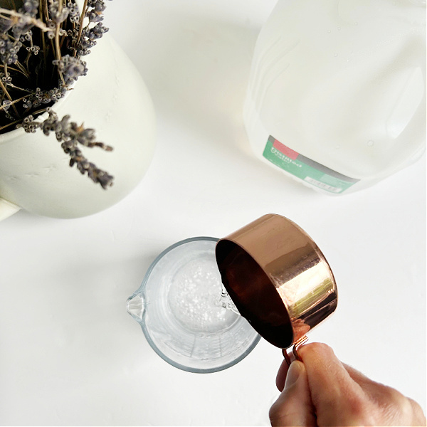 Adding distilled water to linen spray