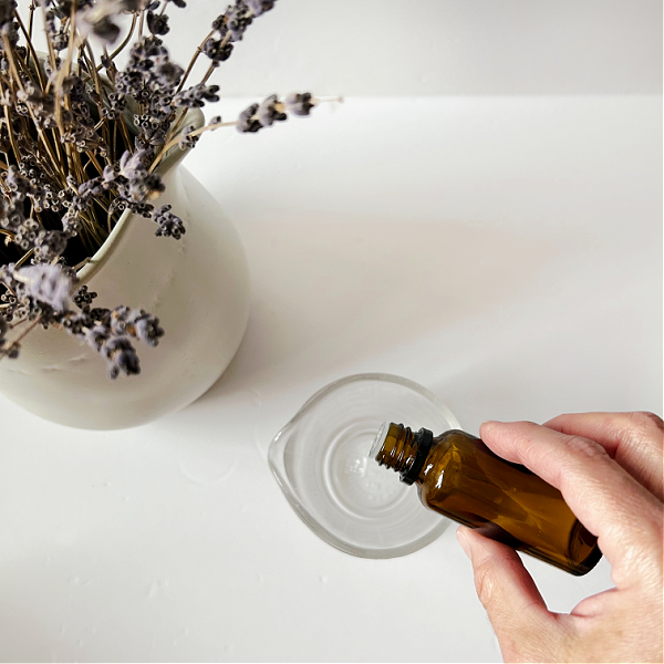 Adding essential oil to homemade linen spray