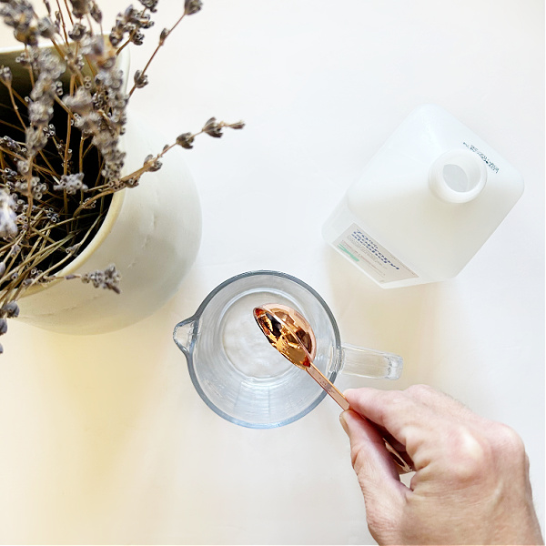 Adding rubbing alcohol to a glass measuring cup