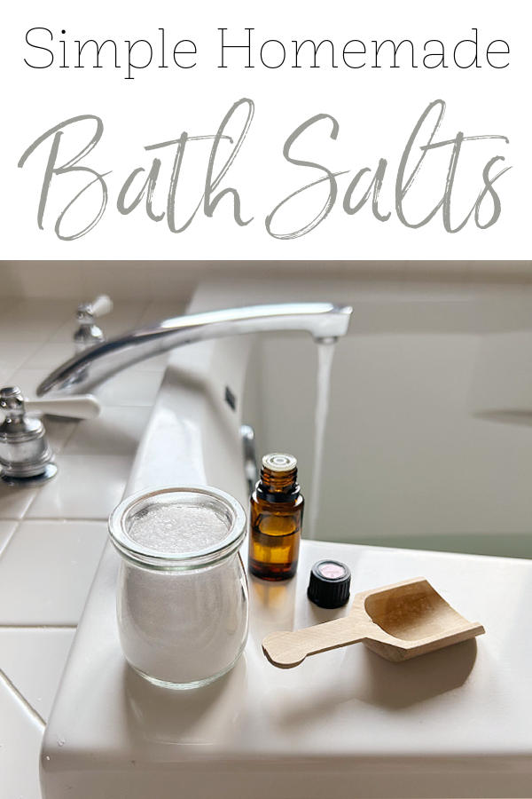 Bath Salts and essential oil sitting on side of bathtub
