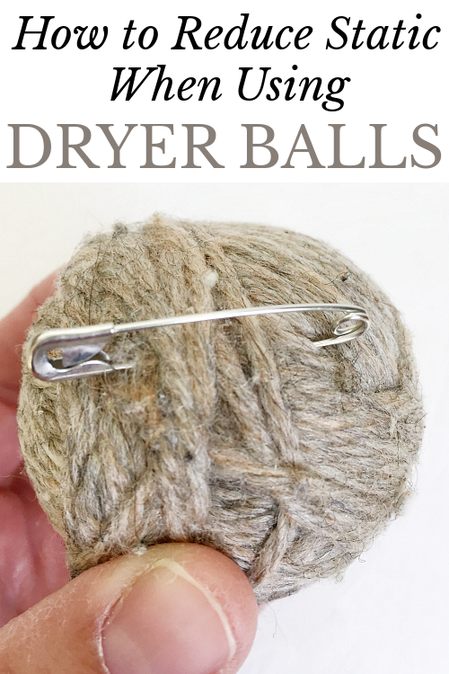 Safety pin attached to wool dryer ball to reduce static