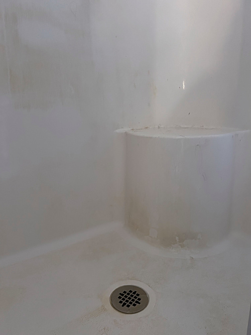 Shower prior to cleaning. Shows lots of rust stains