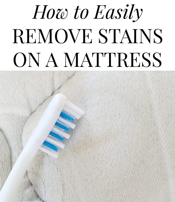 Scrubbing DIY stain remover into a stain on a mattress