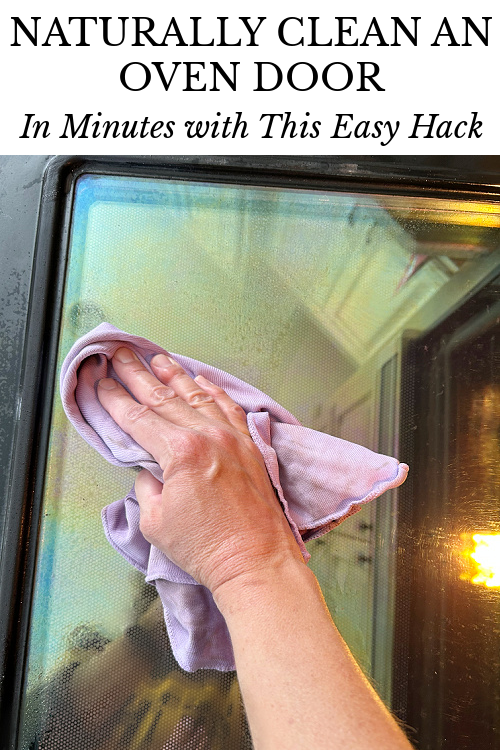 Using window cloth to clean oven door after spraying with glass cleaner