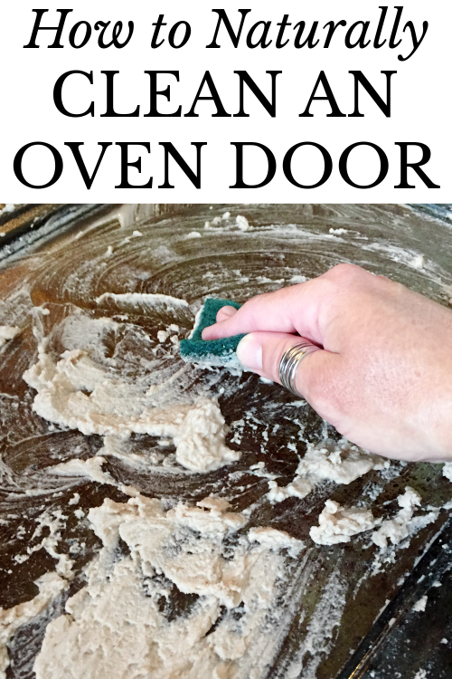 Using a scour pad to clean an oven door