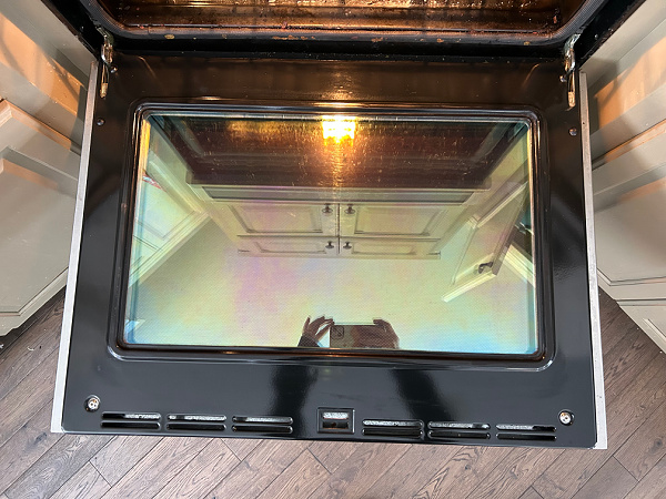 Oven door after cleaning with pumice stone