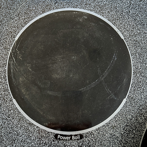 Burner on glass stovetop after cleaning with a pumice stone