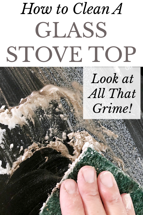 Using a scour pad to clean a glass stove top with baking soda