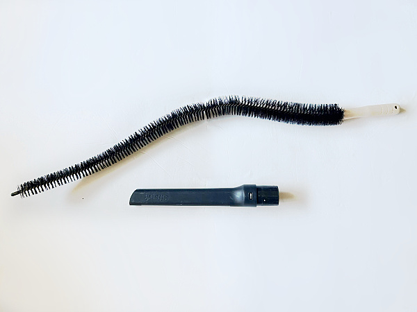 Items needed to clean refrigerator coils: coil brush and vacuum attachment
