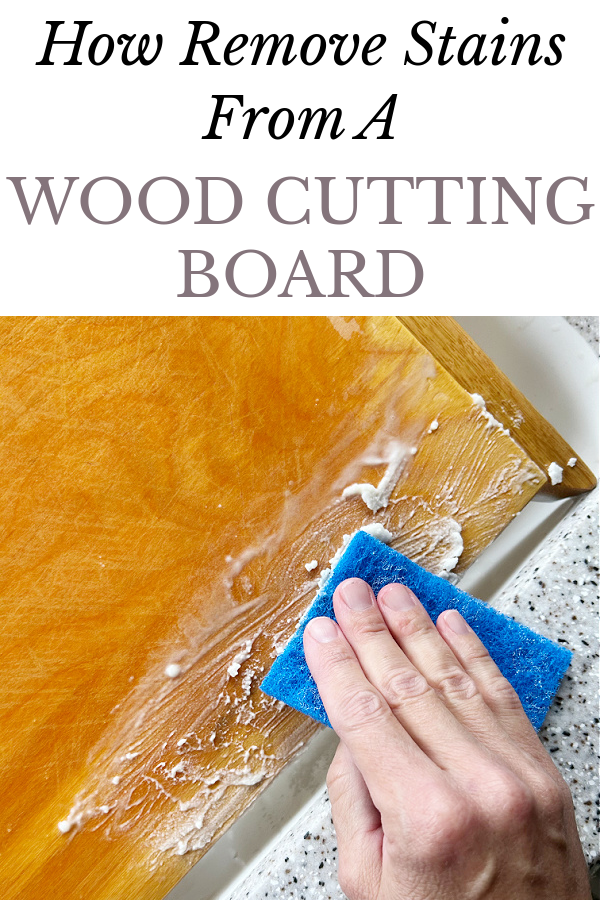 Scrubbing wood cutting board with baking soda to remove stains
