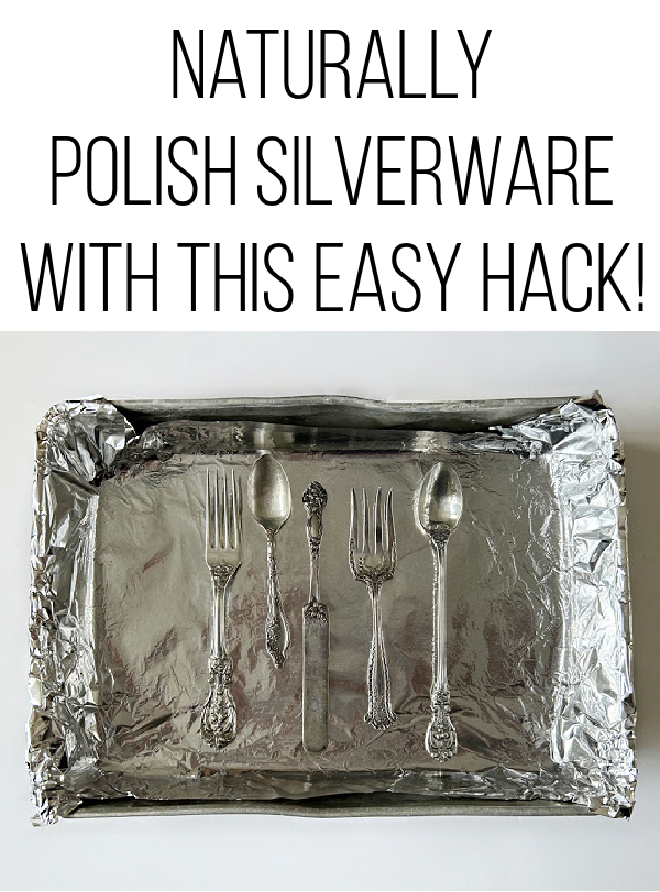 Tarnished silverware in a baking dish covered with aluminum foil
