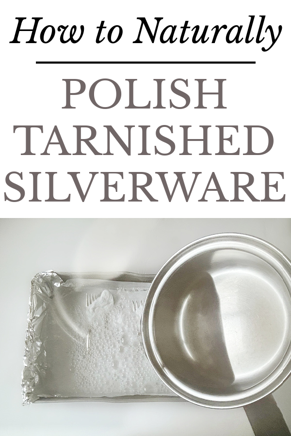 Pouring boiling water over baking soda covered silverware.